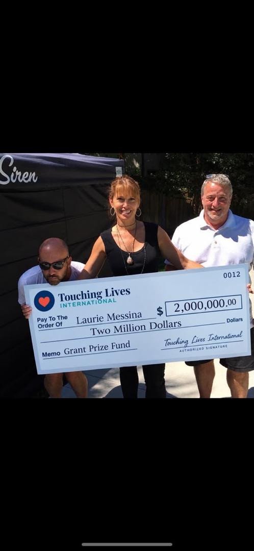 Person holding a presentation cheque indoors