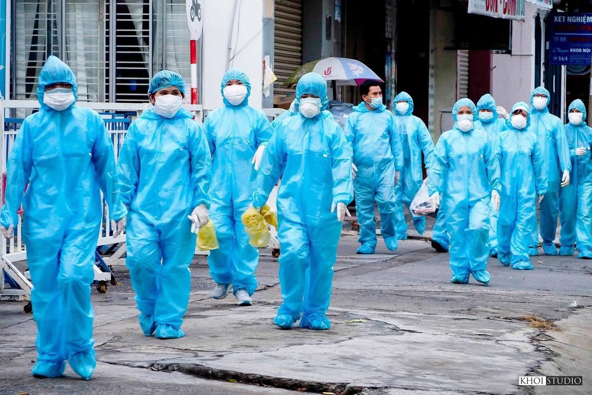 Healthcare workers in protective clothing outdoors