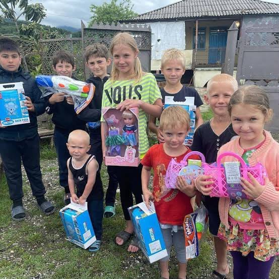 Children and a volunteer gathered outside