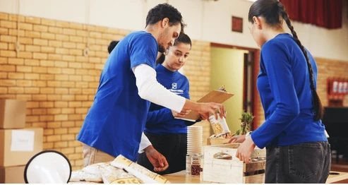 Volunteers serving hot meals to people experiencing homelessness